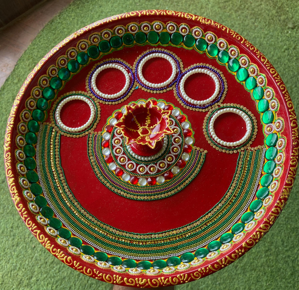 Handcrafted Pooja Thali – top view on green background showing detail